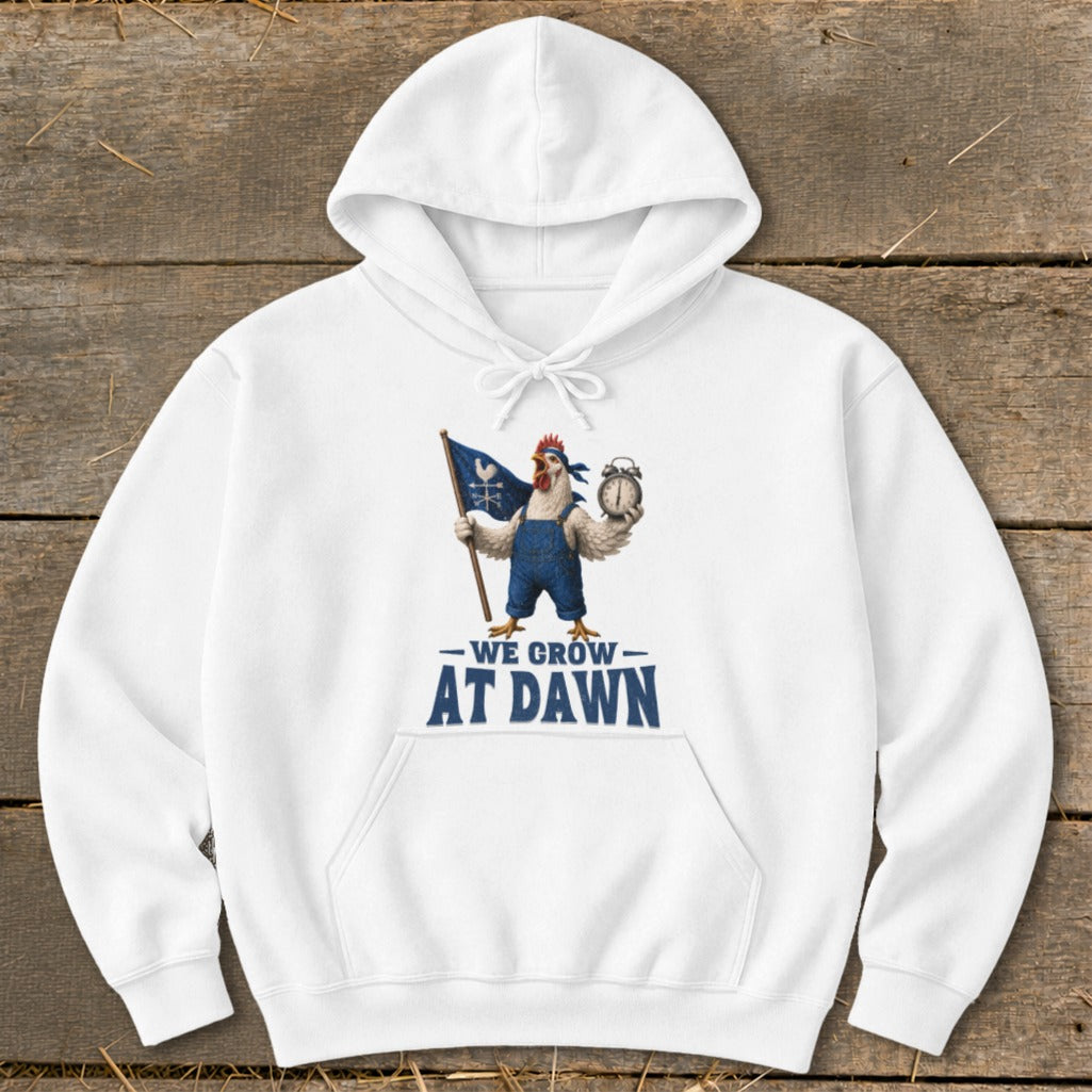 White hoodie with a cartoon chicken holding a flag and alarm clock, text "We Grow At Dawn".