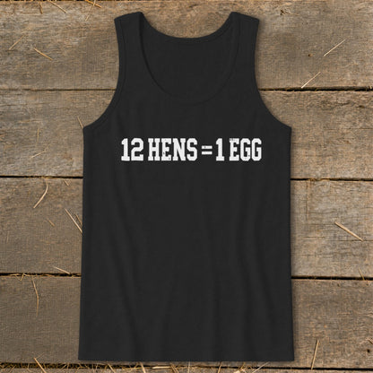 A black tank top with the white text 12 HENS = 1 EGG printed on the chest, lying flat on a wooden surface.