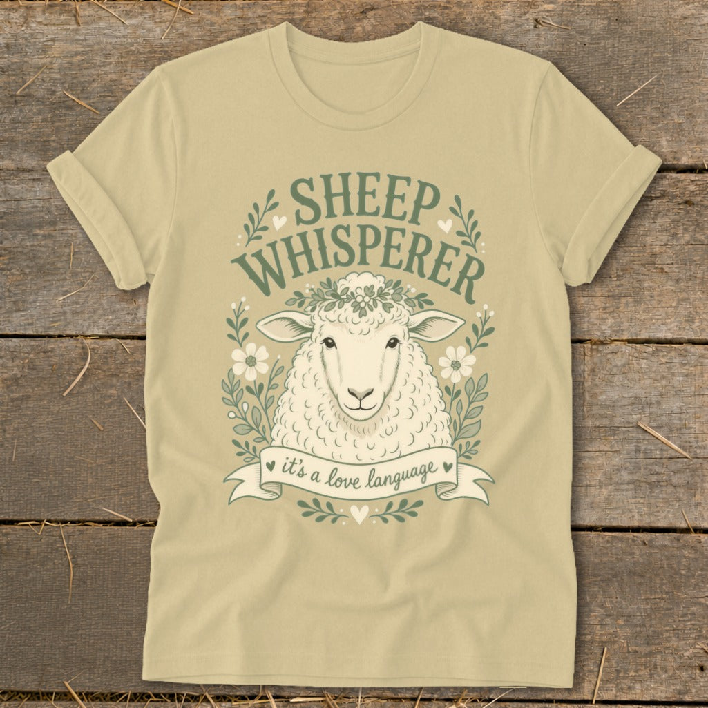 Sheep Whisperer graphic t-shirt with sheep, flowers, and banner saying "it's a love language."