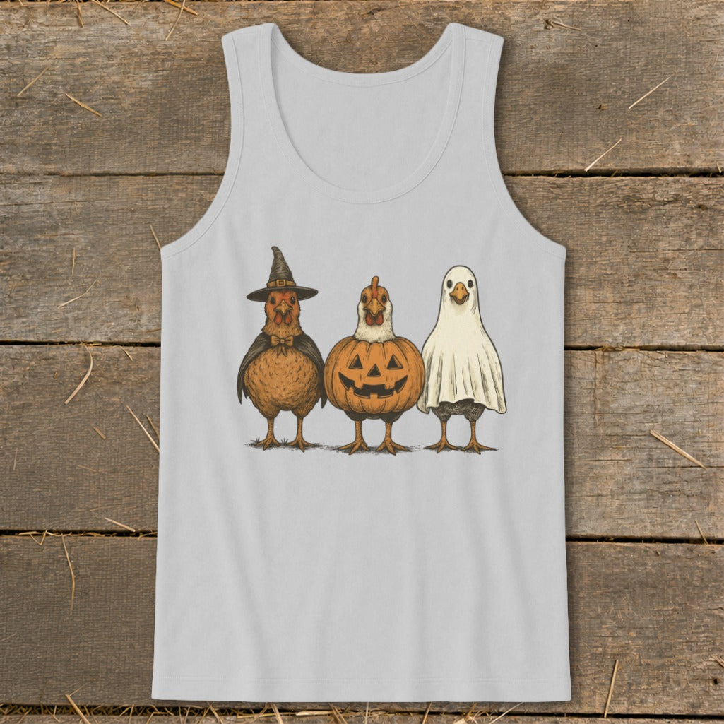 Three chickens dressed for Halloween as a witch, pumpkin, and ghost.