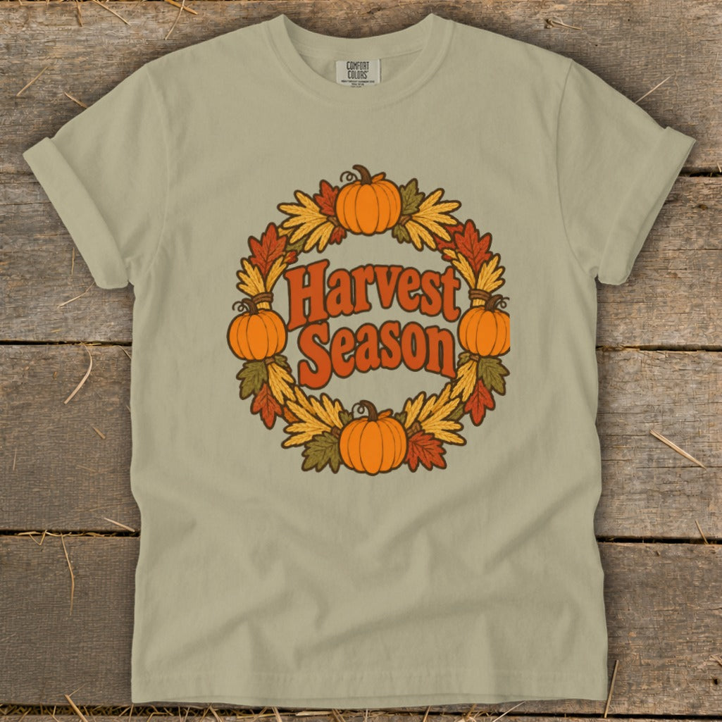 T-shirt with circular fall wreath graphic featuring pumpkins and "Harvest Season" text.