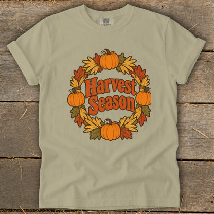 T-shirt with circular fall wreath graphic featuring pumpkins and "Harvest Season" text.