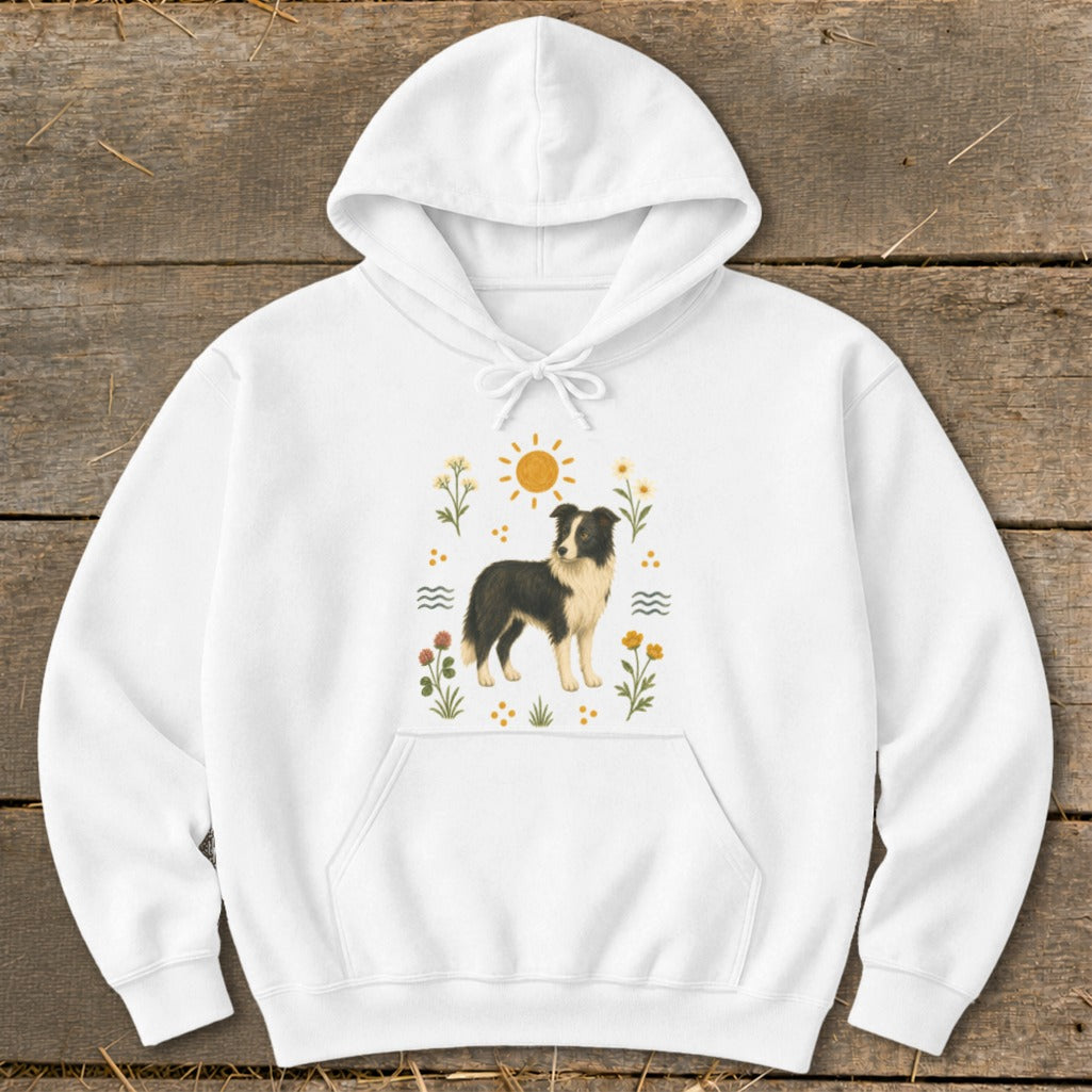 White hoodie featuring a border collie illustration with sun and floral accents.