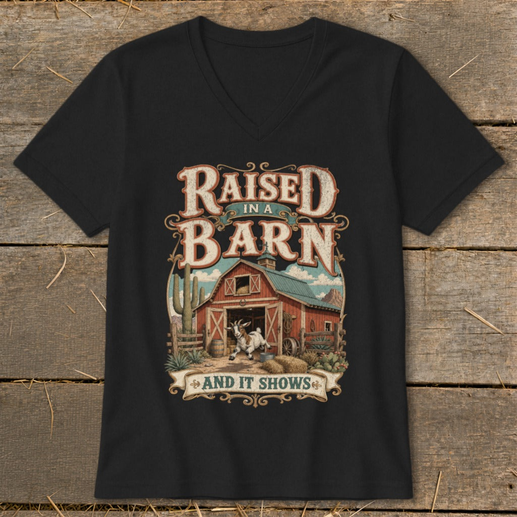 Black v-neck t-shirt featuring a barn, goat, and the text "Raised in a Barn and It Shows".