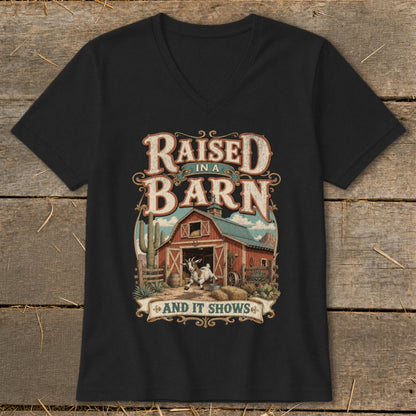 Black v-neck t-shirt featuring a barn, goat, and the text "Raised in a Barn and It Shows".