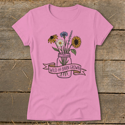 Pink t-shirt with a mason jar of wildflowers and "Wild and Barn Grown" banner.