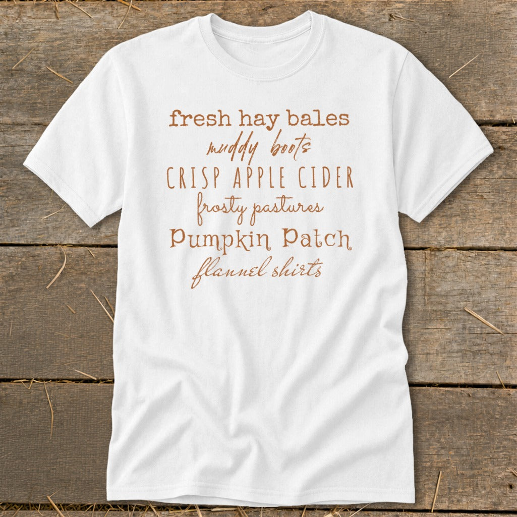White t-shirt with brown text listing fall themes.