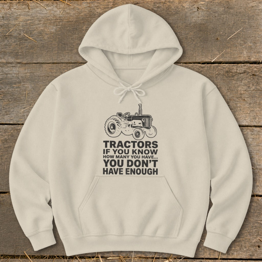 Cream hoodie with tractor graphic and "You Don't Have Enough Tractors" text.