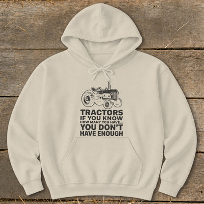 Cream hoodie with tractor graphic and "You Don't Have Enough Tractors" text.