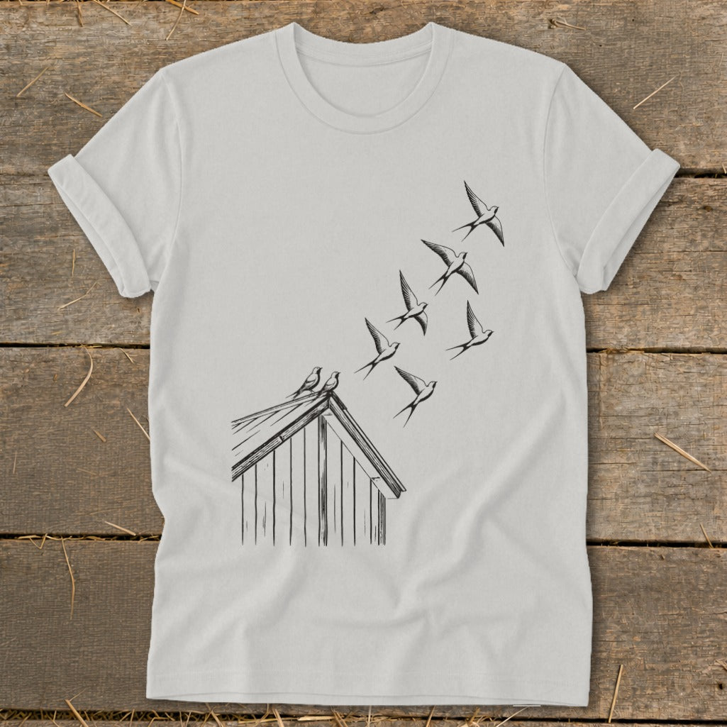 Light gray t-shirt featuring a black line drawing of swallows flying up from a cabin roof.