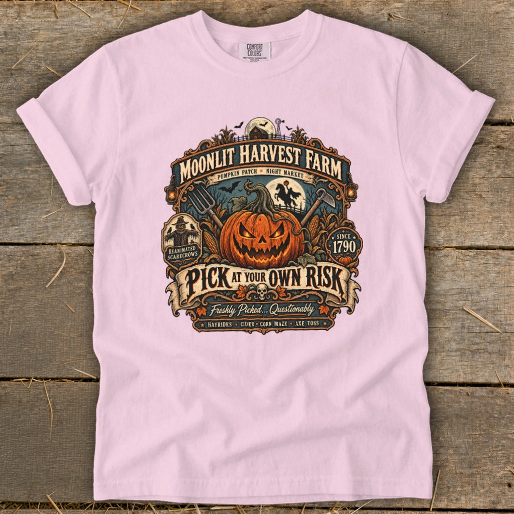 Pink t-shirt with "Moonlit Harvest Farm Pick At Your Own Risk" Halloween graphic.