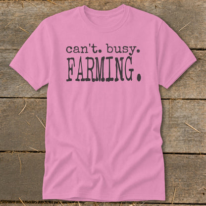 Pink t-shirt with "can't. busy. FARMING." text in dark gray.