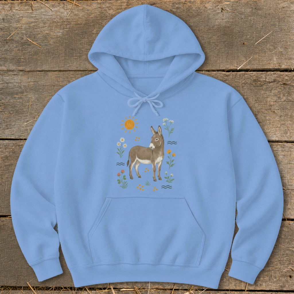 Light blue hoodie with a watercolor illustration of a donkey surrounded by wildflowers and a sun.