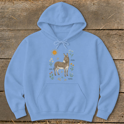 Light blue hoodie with a watercolor illustration of a donkey surrounded by wildflowers and a sun.