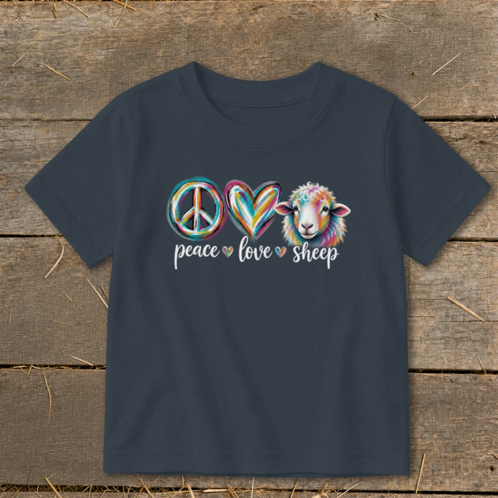 Dark t-shirt with peace, heart, and sheep graphics with text "peace love sheep".