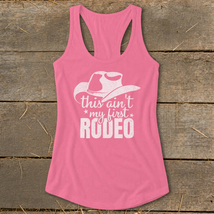 Pink tank top with white cowboy hat and "This ain't my first Rodeo" text.