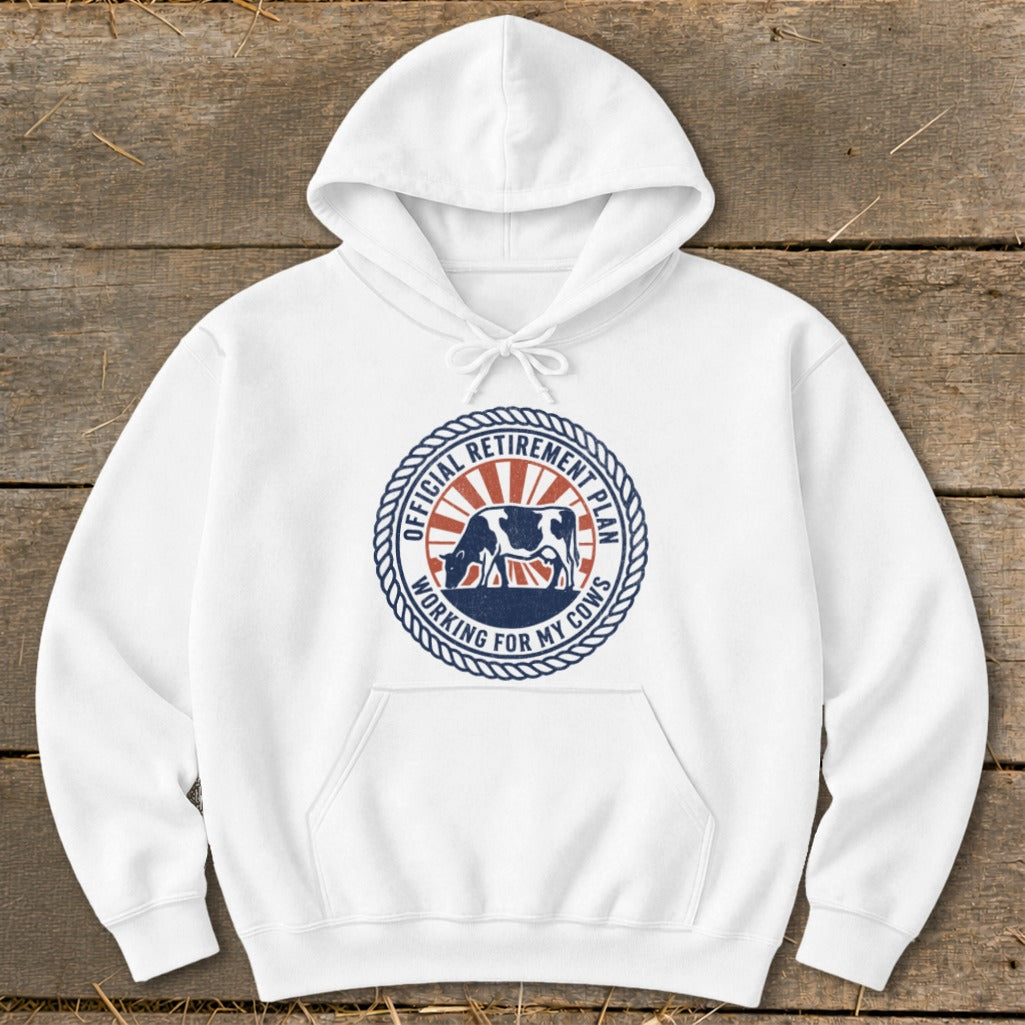 White hoodie with a circular graphic reading "Official Retirement Plan Working for My Cows."