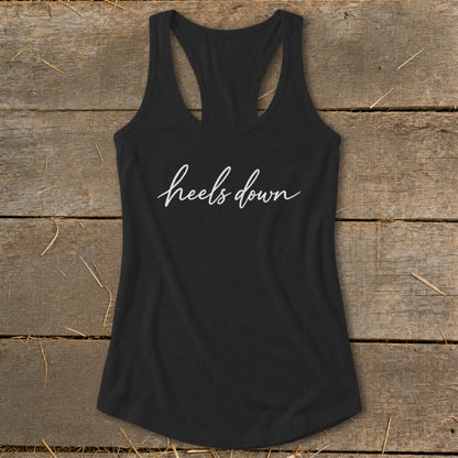 Black racerback tank top with white script text "heels down".