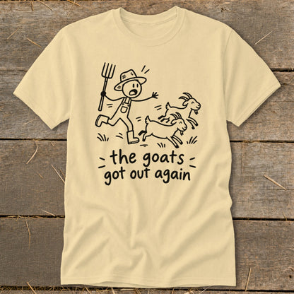 Light yellow t-shirt with a cartoon of a farmer chasing goats and the text "the goats got out again".