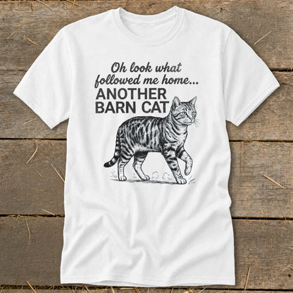 White t-shirt with text "Oh look what followed me home... ANOTHER BARN CAT" and a tabby cat illustration.