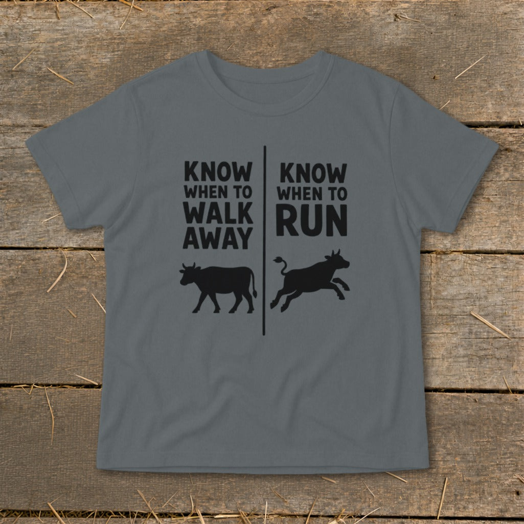 Gray t-shirt with black text "KNOW WHEN TO WALK AWAY" and "KNOW WHEN TO RUN" over cow silhouettes.