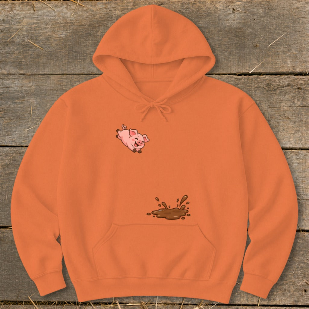 Orange hoodie with a cartoon pig jumping into a mud puddle graphic.