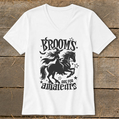 White v-neck t-shirt with "Brooms are for amateurs" and witch on horse graphic.