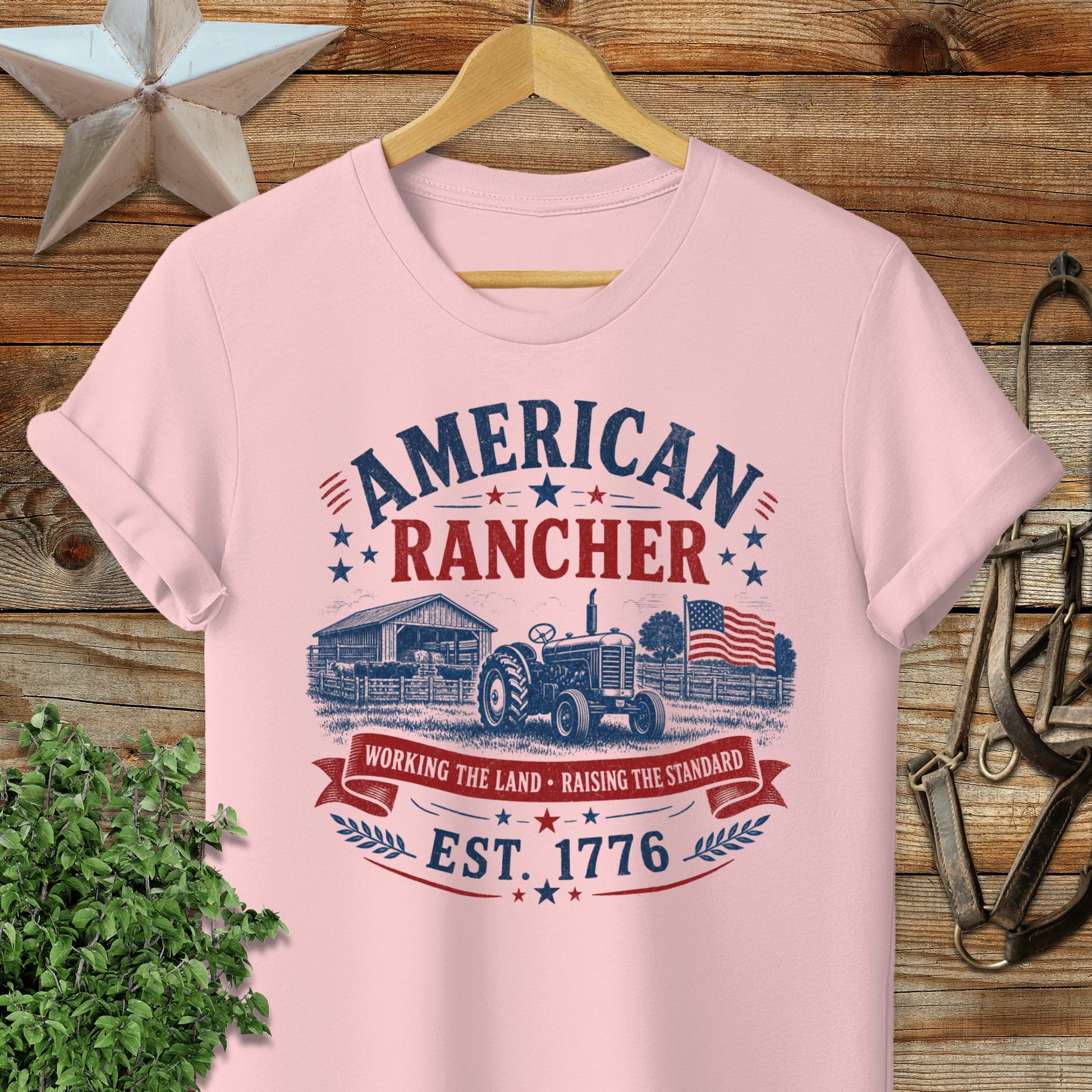 Pink t-shirt with "American Rancher" and "Est. 1776" in vintage distressed graphic.