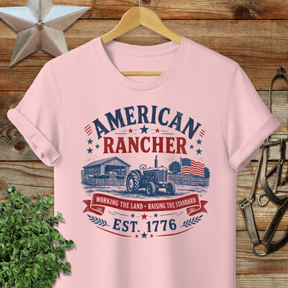 Pink t-shirt with "American Rancher" and "Est. 1776" in vintage distressed graphic.