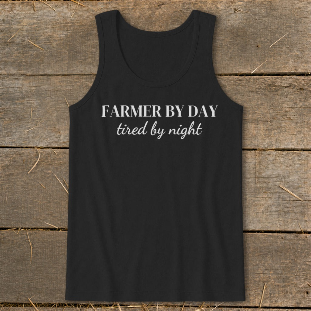 Black tank top with white text "Farmer by day, tired by night."