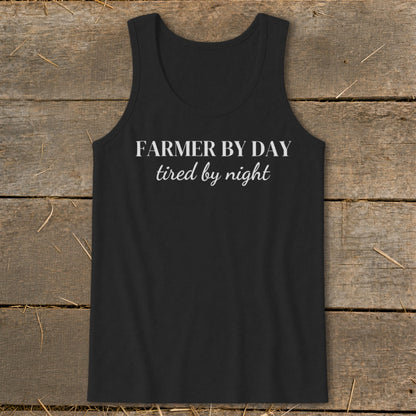 Black tank top with white text "Farmer by day, tired by night."