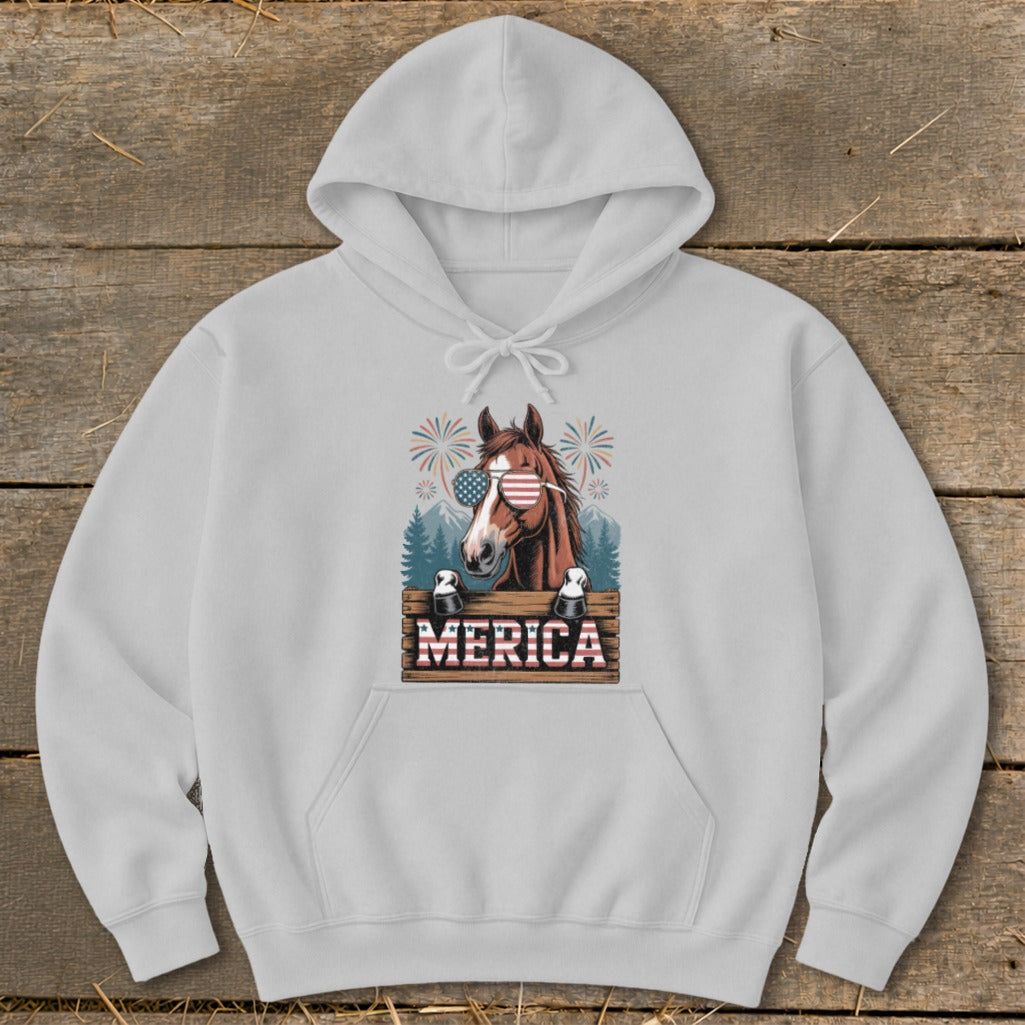 Horse wearing American flag sunglasses with "MERICA" text and fireworks design.
