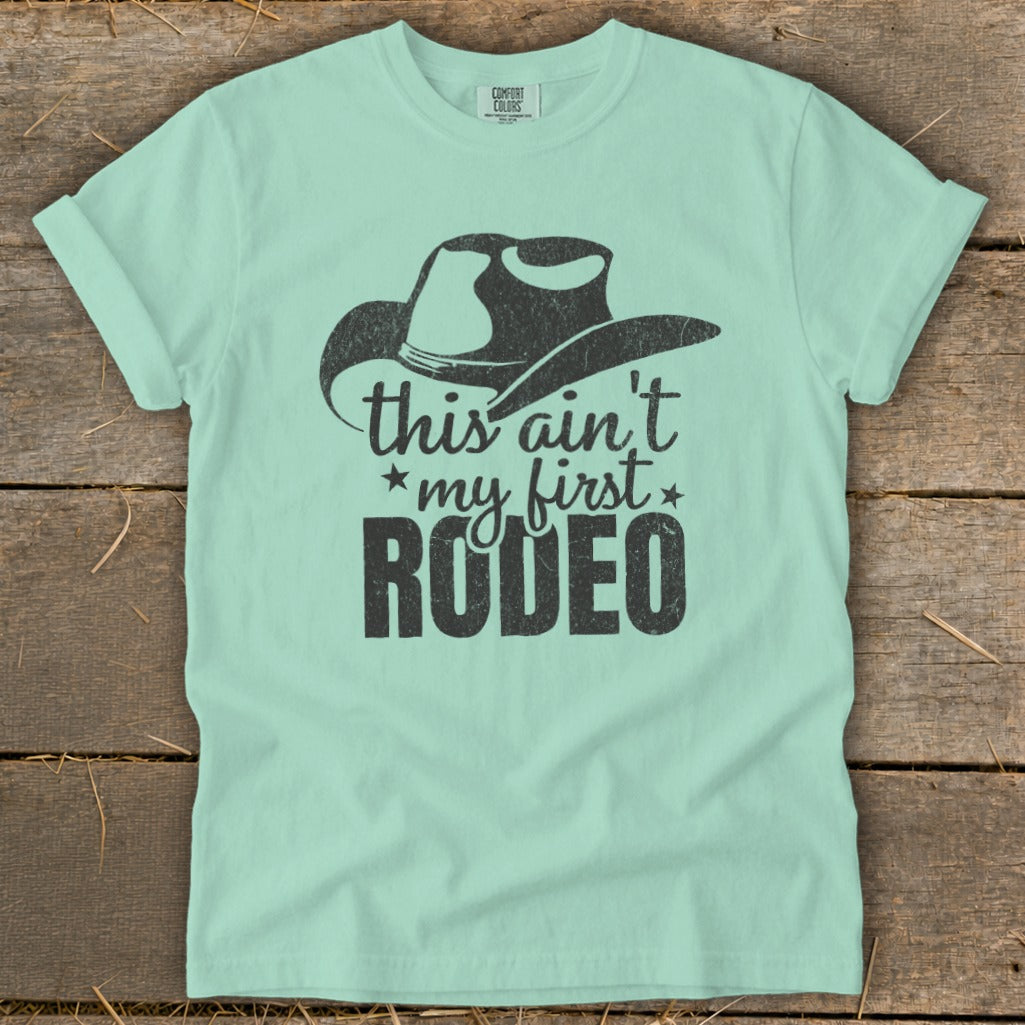 Light blue t-shirt with cowboy hat graphic and text "this ain't my first RODEO".