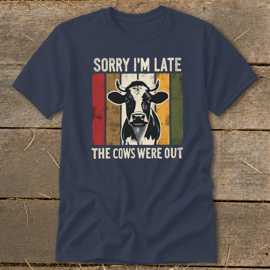 Navy t-shirt with a cow graphic and text "SORRY I'M LATE THE COWS WERE OUT".