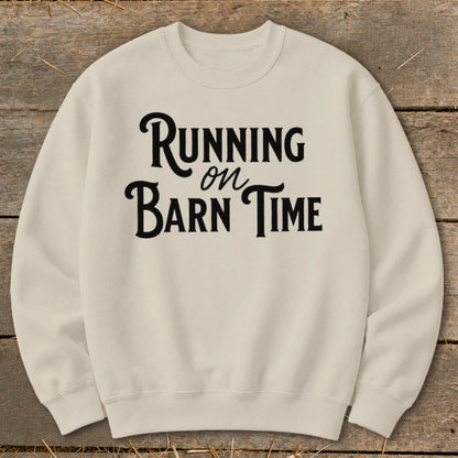 Cream sweatshirt with black text that reads "Running on Barn Time".