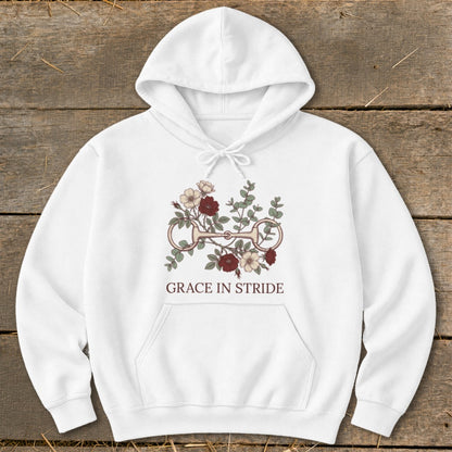 White hoodie with floral bit graphic and text "Grace in Stride."