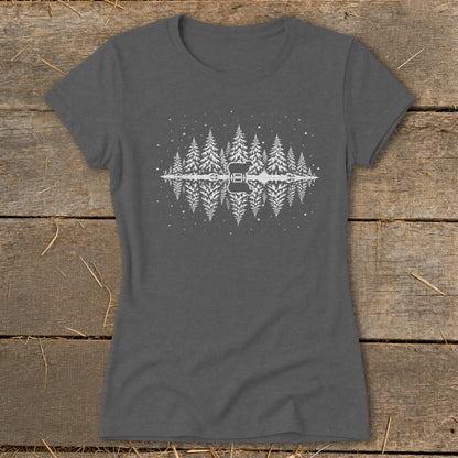T-shirt with white graphic of pine trees, a silhouette of a deer, and reflection in water.