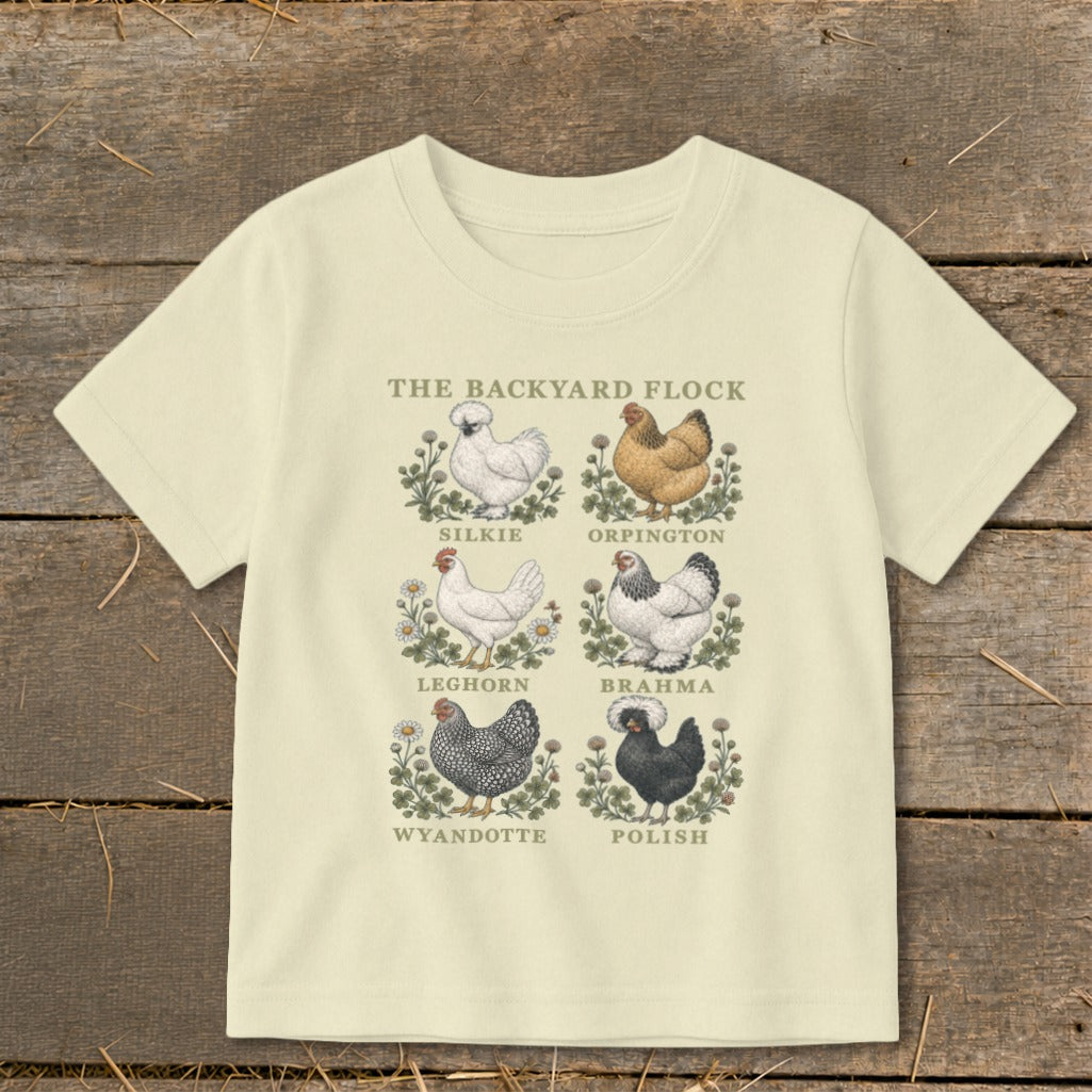 Cream t-shirt with "The Backyard Flock" title and six chicken illustrations with their breeds labeled.