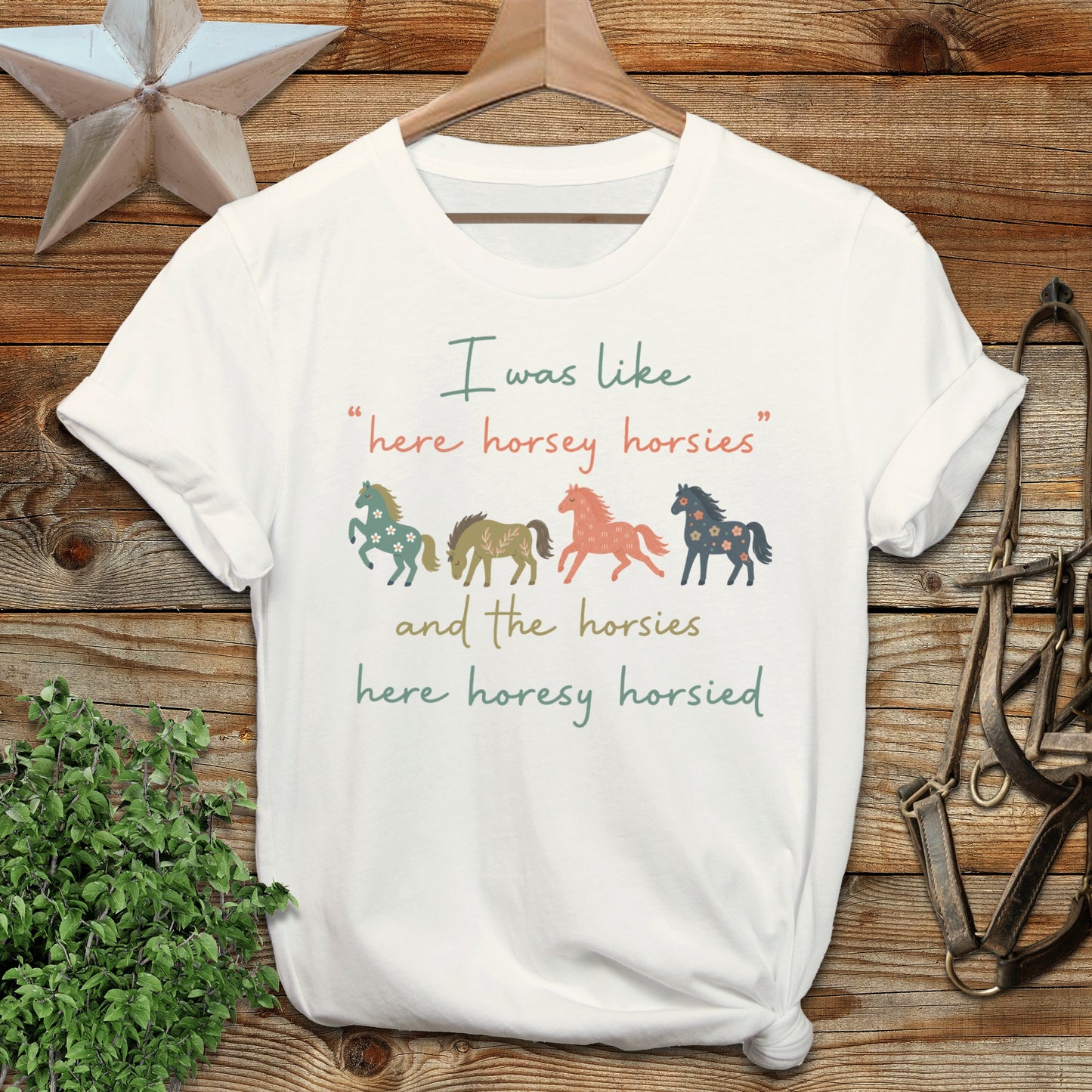White t-shirt with "here horsey horsies" quote and floral horse illustrations.