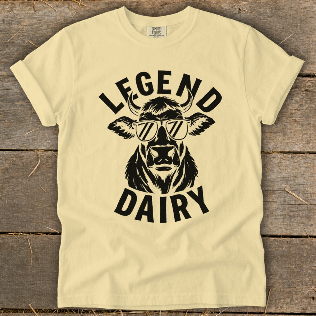 Cream t-shirt with black graphic of a cow wearing sunglasses and text "LEGEND DAIRY."