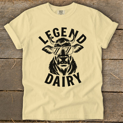 Cream t-shirt with black graphic of a cow wearing sunglasses and text "LEGEND DAIRY."