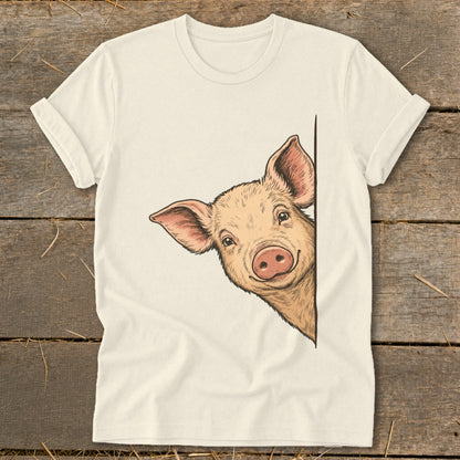 Cream t-shirt with a drawing of a smiling pig peeking from the side.