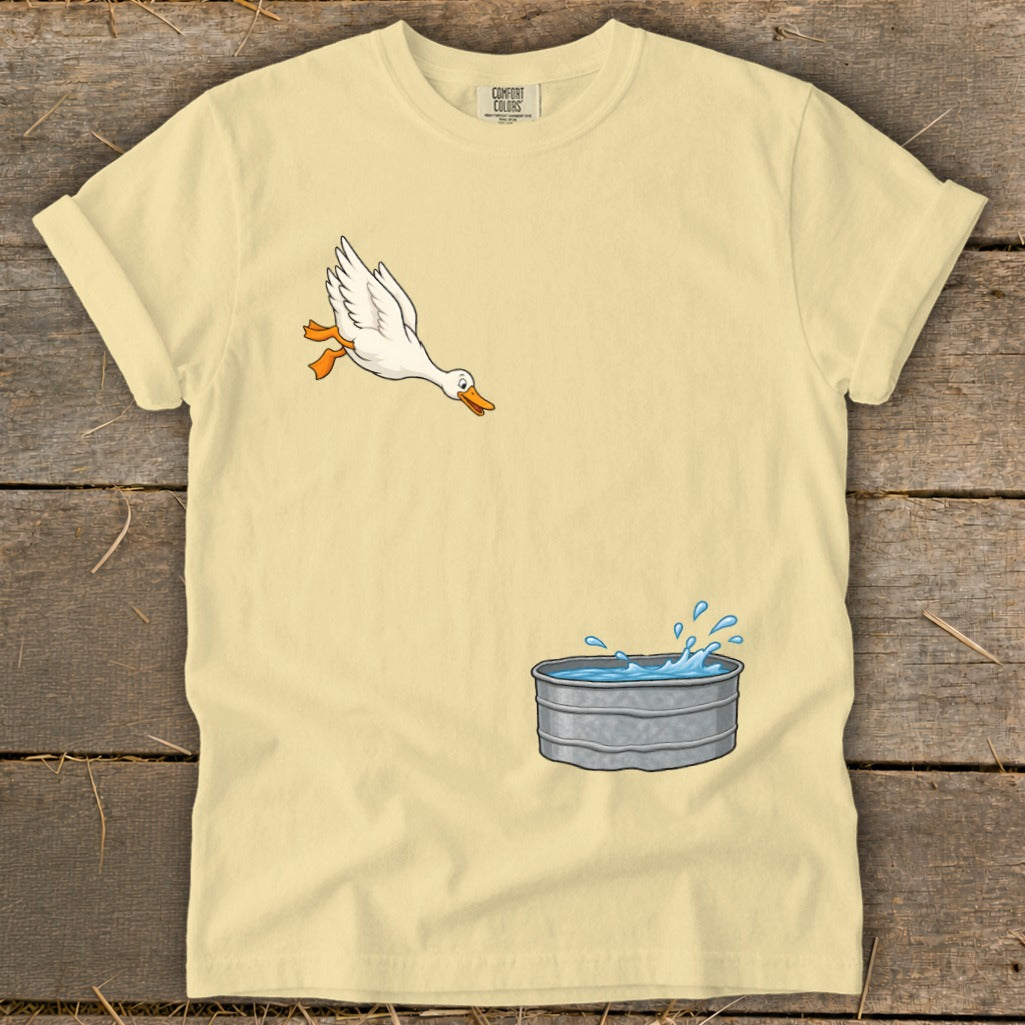 Yellow t-shirt with a cartoon goose jumping into a galvanized tub of water.