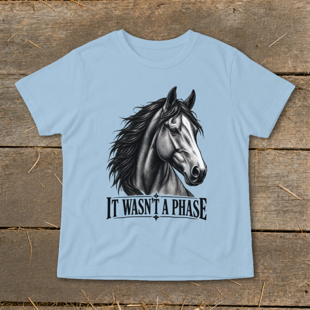 Light blue t-shirt with a black and white drawing of a horse's head and the text "IT WASN'T A PHASE".