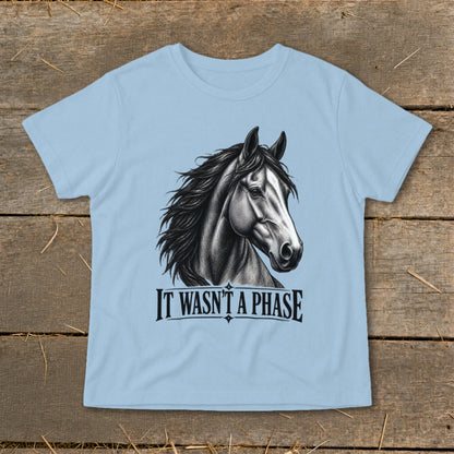 Light blue t-shirt with a black and white drawing of a horse's head and the text "IT WASN'T A PHASE".