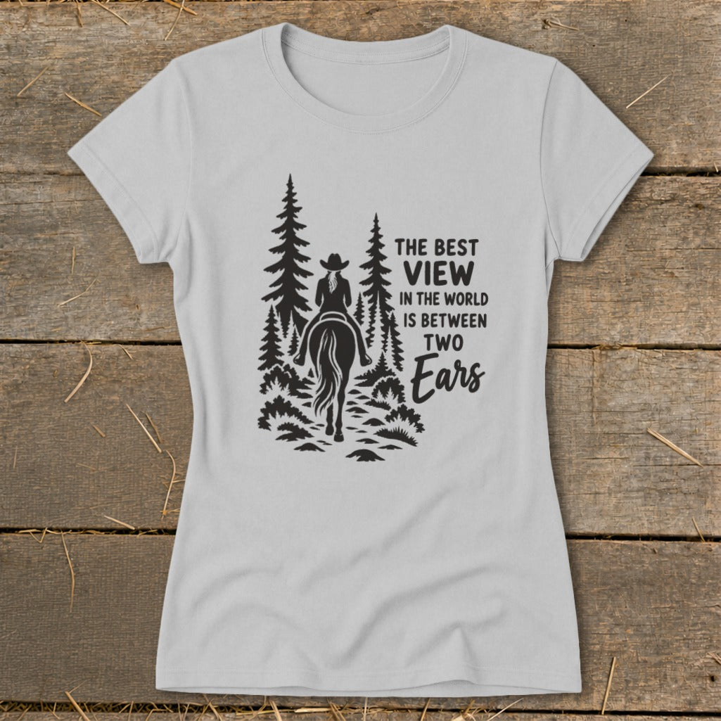 Light gray women's t-shirt featuring a black silhouette graphic of a horseback rider and pine trees with text.