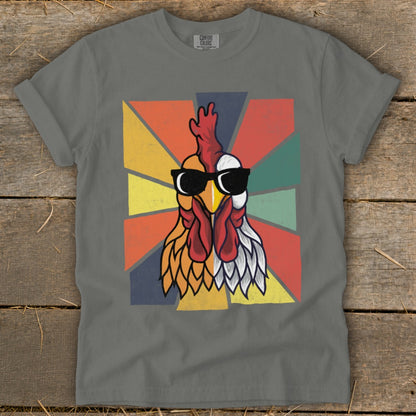 Grey t-shirt with a retro chicken graphic wearing sunglasses on a colorful background.