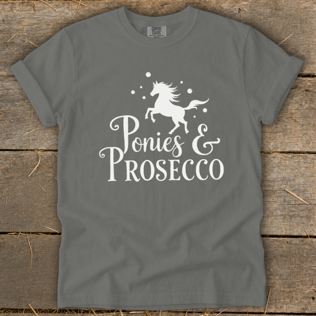 Grey t-shirt with white text and a graphic of a pony and bubbles reading "Ponies & Prosecco".