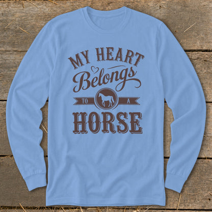 Light blue long-sleeve shirt with brown text "My heart belongs to a horse."