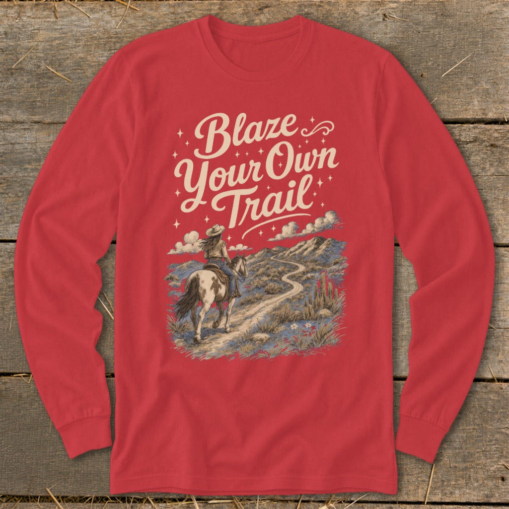 Red long-sleeve shirt with "Blaze Your Own Trail" text and equestrian desert landscape graphic.